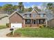 Beautiful brick home with an attached garage and a well-maintained front yard at 8215 Cushing St, Raleigh, NC 27613