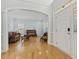 Welcoming foyer with hardwood floors, an arched entry, and a view into the living area at 8215 Cushing St, Raleigh, NC 27613