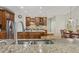 Spacious kitchen features wood cabinets, granite countertops, stainless steel appliances, and a central island with sink at 8215 Cushing St, Raleigh, NC 27613