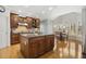 Large kitchen with wood cabinets, granite countertops, stainless steel appliances and eating area with arched windows at 8215 Cushing St, Raleigh, NC 27613