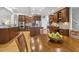 Open kitchen featuring wood cabinets, stainless appliances, granite countertops, and an island at 8215 Cushing St, Raleigh, NC 27613