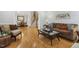 Spacious living room with hardwood floors, comfortable seating, and an open archway at 8215 Cushing St, Raleigh, NC 27613