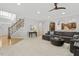 Open-concept space featuring a staircase, living room area, and kitchen at 8215 Cushing St, Raleigh, NC 27613