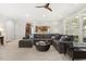 Large living room with a sectional sofa, ceiling fan, and open layout to kitchen at 8215 Cushing St, Raleigh, NC 27613
