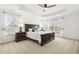 Spacious main bedroom suite featuring a trey ceiling, carpet, and bedside tables at 8215 Cushing St, Raleigh, NC 27613