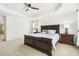 Large main bedroom with trey ceiling, ceiling fan, bedside tables, and lots of natural light at 8215 Cushing St, Raleigh, NC 27613