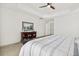 Bright main bedroom featuring neutral carpet, side tables, and a ceiling fan at 8215 Cushing St, Raleigh, NC 27613
