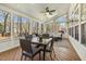 Cozy sunroom with ample natural light, comfortable seating, and wooded backyard view at 8215 Cushing St, Raleigh, NC 27613