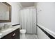 Bathroom featuring a vanity with granite countertop, framed mirror and a shower with patterned curtain at 8310 Wycombe Ln, Raleigh, NC 27615