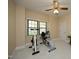 A bright exercise room with large windows, neutral paint, and a ceiling fan at 8310 Wycombe Ln, Raleigh, NC 27615
