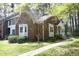 Lovely brick home with mature tree in the yard, charming cream trim, and inviting front porch at 8310 Wycombe Ln, Raleigh, NC 27615
