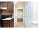The Kitchen features dark wood cabinets and granite countertops; it offers seamless transition into other parts of the home at 8310 Wycombe Ln, Raleigh, NC 27615