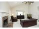 Spacious living room boasts a fireplace, vaulted ceiling, and stylish leather furniture at 8310 Wycombe Ln, Raleigh, NC 27615
