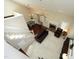 Aerial view of living room boasting fireplace, vaulted ceilings, and open to a breakfast nook at 8310 Wycombe Ln, Raleigh, NC 27615