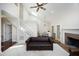 Open-concept living room featuring a fireplace, vaulted ceilings, and an elegant staircase at 8310 Wycombe Ln, Raleigh, NC 27615