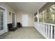 A covered porch with a seating area perfect for outdoor relaxation and enjoyment at 8310 Wycombe Ln, Raleigh, NC 27615