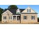Charming brick home with stylish shutters, a covered entryway, and a well-manicured lawn at 835 Emmett Ct, Spring Hope, NC 27882