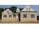 Brick home with black shutters and a covered front porch featuring traditional design and curb appeal at 835 Emmett Ct, Spring Hope, NC 27882