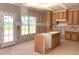 Bright kitchen with natural wood cabinets, central island, and natural light offering potential for a dream kitchen at 835 Emmett Ct, Spring Hope, NC 27882