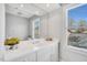 Modern bathroom featuring a white vanity, a large mirror, and a window at 10 E Madison, Pittsboro, NC 27312