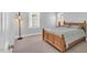 Bedroom with light gray walls, window with blinds, and a wooden bed frame at 10 E Madison, Pittsboro, NC 27312