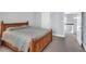 Bedroom with gray walls, wooden bed frame, and an open door with stairway access at 10 E Madison, Pittsboro, NC 27312