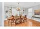 Elegant dining room boasts hardwood floors, a chandelier, and custom built-in shelving at 10 E Madison, Pittsboro, NC 27312