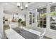 Bright dining room with a white table, leading to a kitchen view at 10 E Madison, Pittsboro, NC 27312