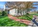 Home exterior with manicured lawn, brick walkway, and mature trees shading the property at 10 E Madison, Pittsboro, NC 27312