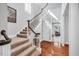 Elegant foyer with hardwood floors, staircase, and natural light streaming through windows at 10 E Madison, Pittsboro, NC 27312
