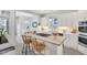 Bright kitchen showcases a center island cooktop with barstool seating and modern appliances at 10 E Madison, Pittsboro, NC 27312
