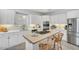 Modern kitchen featuring white cabinetry, stainless steel appliances, and a center island with seating at 10 E Madison, Pittsboro, NC 27312
