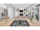 Modern kitchen features a gas range cooktop on an island with a stainless steel refrigerator at 10 E Madison, Pittsboro, NC 27312