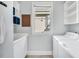 Well-organized laundry room with washer, dryer, sink, and ample storage shelves at 10 E Madison, Pittsboro, NC 27312