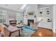 Bright living room with fireplace, built-in shelving, and a skylight for natural light at 10 E Madison, Pittsboro, NC 27312
