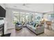 Sunroom with a fireplace and large windows offering views of the outdoor greenery at 10 E Madison, Pittsboro, NC 27312