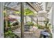 Relaxing patio with a pergola, dining set, ambient lighting, lush garden and rock waterfall at 10 E Madison, Pittsboro, NC 27312