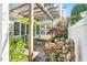 Inviting patio area with pergola, outdoor furniture, lush landscaping, and a water feature at 10 E Madison, Pittsboro, NC 27312