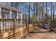 An outdoor deck featuring wooden floors with views into a lush, wooded yard at 101 Barriedale Cir, Cary, NC 27519