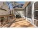A spacious outdoor deck with a grill, connecting to the sunroom at 101 Barriedale Cir, Cary, NC 27519