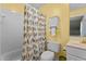 Bright bathroom with a shower-tub combo, colorful shower curtain, and decorative storage cabinet at 101 Barriedale Cir, Cary, NC 27519