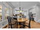 Open concept dining area with hardwood floors, a view into the kitchen, and lots of natural light at 101 Barriedale Cir, Cary, NC 27519