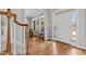 Bright foyer with hardwood floors, white door, and staircase at 101 Barriedale Cir, Cary, NC 27519