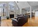 Spacious living room with large windows, a fireplace, and hardwood floors at 101 Barriedale Cir, Cary, NC 27519