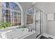 Luxurious main bathroom with a soaking tub, separate shower, and large window overlooking trees at 101 Barriedale Cir, Cary, NC 27519