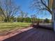 Landscaped backyard with a wooden deck, large trees and a storage shed at 10317 Lake Wheeler Rd, Fuquay Varina, NC 27526