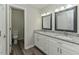 Bright bathroom featuring double sinks with granite countertops and modern fixtures at 10317 Lake Wheeler Rd, Fuquay Varina, NC 27526