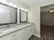 Bright bathroom featuring double sinks with granite countertops and modern fixtures at 10317 Lake Wheeler Rd, Fuquay Varina, NC 27526