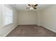 Spacious bedroom with neutral carpeting, a ceiling fan and a bright window at 10317 Lake Wheeler Rd, Fuquay Varina, NC 27526