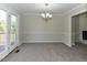Open dining area with carpeted floors, leading to outdoor deck, and features modern lighting at 10317 Lake Wheeler Rd, Fuquay Varina, NC 27526